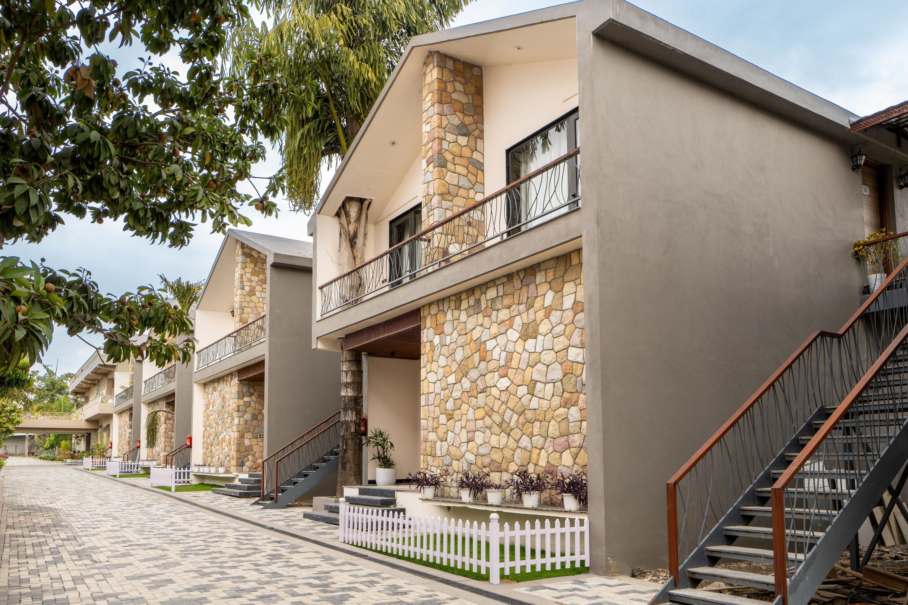 A building with a stone facade, balconies, and a staircase.