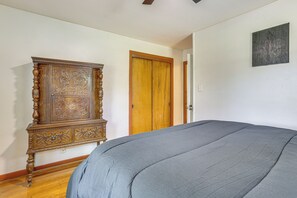 Ein Zimmer mit einem großen Bett, einem Holzschrank und einer Tür.