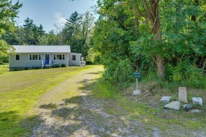 A single-story house with a front porch, a small yard, and a private property sign. - Welcome to Buck's Hideout in Bridgton Maine! (Bridgton)