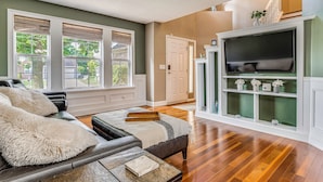 A living room with a fireplace, a sofa, and a television. - Treehouse Views! Walking Distance to IMS (Indianapolis)
