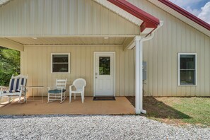 A building with a covered porch, a door, and two windows. - Hunt & Fish! Home < 1 Mi to Broad River Campground (Tignall)