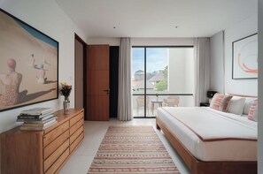 Un dormitorio moderno con una cama grande, un aparador de madera, un cuadro y un balcón con vistas.