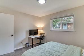 A bedroom with a bed, a desk with a computer, a chair, a window, and a lamp. - 12 Mi to Red Rocks, Dtwn Denver! Townhome w/ Patio (Arvada)