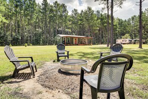 A cabin with a porch, a fire pit, and two Adirondack chairs. - Cabin is 2 Miles From Bogue Chitto State Park (Franklinton)