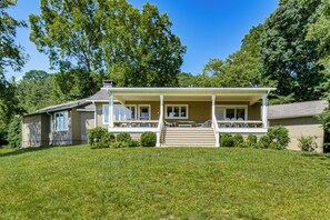 A two-story house with a covered porch, a front yard, and a satellite dish. - Mountain Home Near Lake Glenville w/ Scenic Views (Cullowhee)