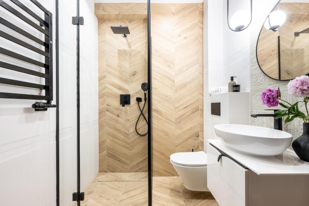 A modern bathroom with a shower, toilet, and sink.