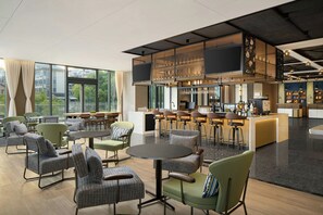 A modern bar area with seating and a bar counter. - Four Points by Sheraton Nanjing, Gulou District (Nanjing)