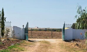 A gated entrance with a clear path leading to a building.