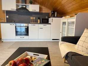 A modern kitchen with a built-in oven, microwave, and a coffee maker. - Allalinblick by Interhome (Saas-Grund)