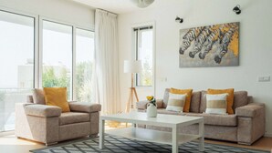 A modern living room with two sofas, a coffee table, and a painting of zebras. - 3BR Panoramic Sea View Villa with Private Pool (Pissouri)