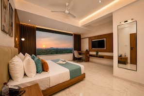 A modern hotel room with a bed, desk, and large TV. - Aarambh by The Sky Imperial Jamnagar (Jamnagar)