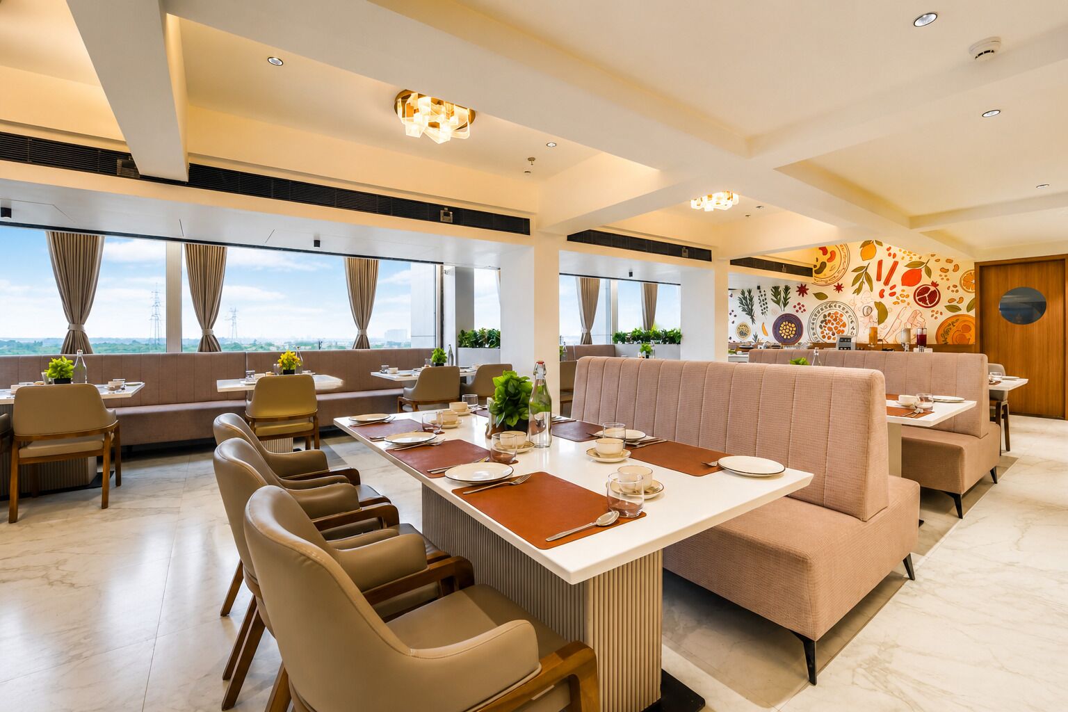 A modern dining area with a long table, cushioned seating, and a city view.