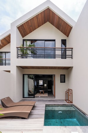 A modern two-story house with a swimming pool, wooden deck, and outdoor seating. - Unique and Stylish Villa w/ Plunge Pool Near beach (Canggu)
