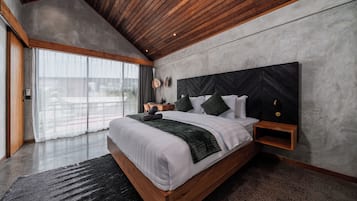 A modern bedroom with a large bed, wooden headboard, and a view through large windows.