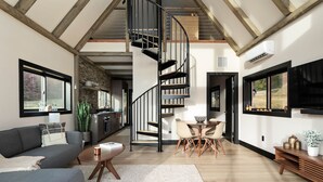 A modern interior with a spiral staircase, a dining area, and a living room with a sofa and coffee table. - The Lakeside Cabin at Arete (Page County)