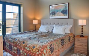 A bedroom with a large bed, two bedside lamps, a framed artwork on the wall, and a view through an open door. - Gorgeous home in Kivik with WiFi (Kivik)