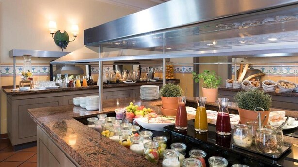 Una barra de buffet con diversas opciones de comida y bebidas.