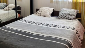 A bedroom with a bed, a wardrobe, a window with curtains, and a wall-mounted picture. - 3-bedroom house in serene Carry-le-Rouet with cool AC (Carry-le-Rouet)