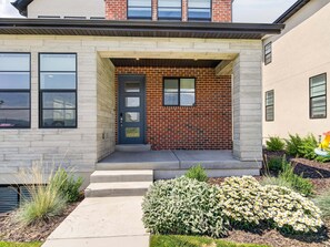 A modern house with a brick facade, a dark front door, and a small porch with steps leading to the entrance. - New! Deer Valley Close, 4BR 3.5BA, Sleeps 11, BBQ (Heber City)