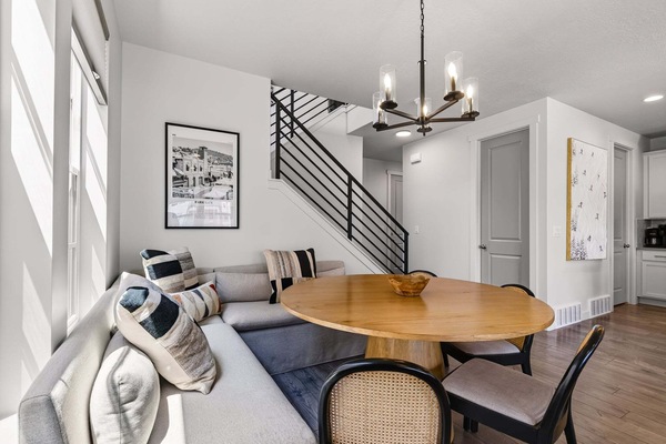Seating for 8 at the large round dining room table with bench and chair seating