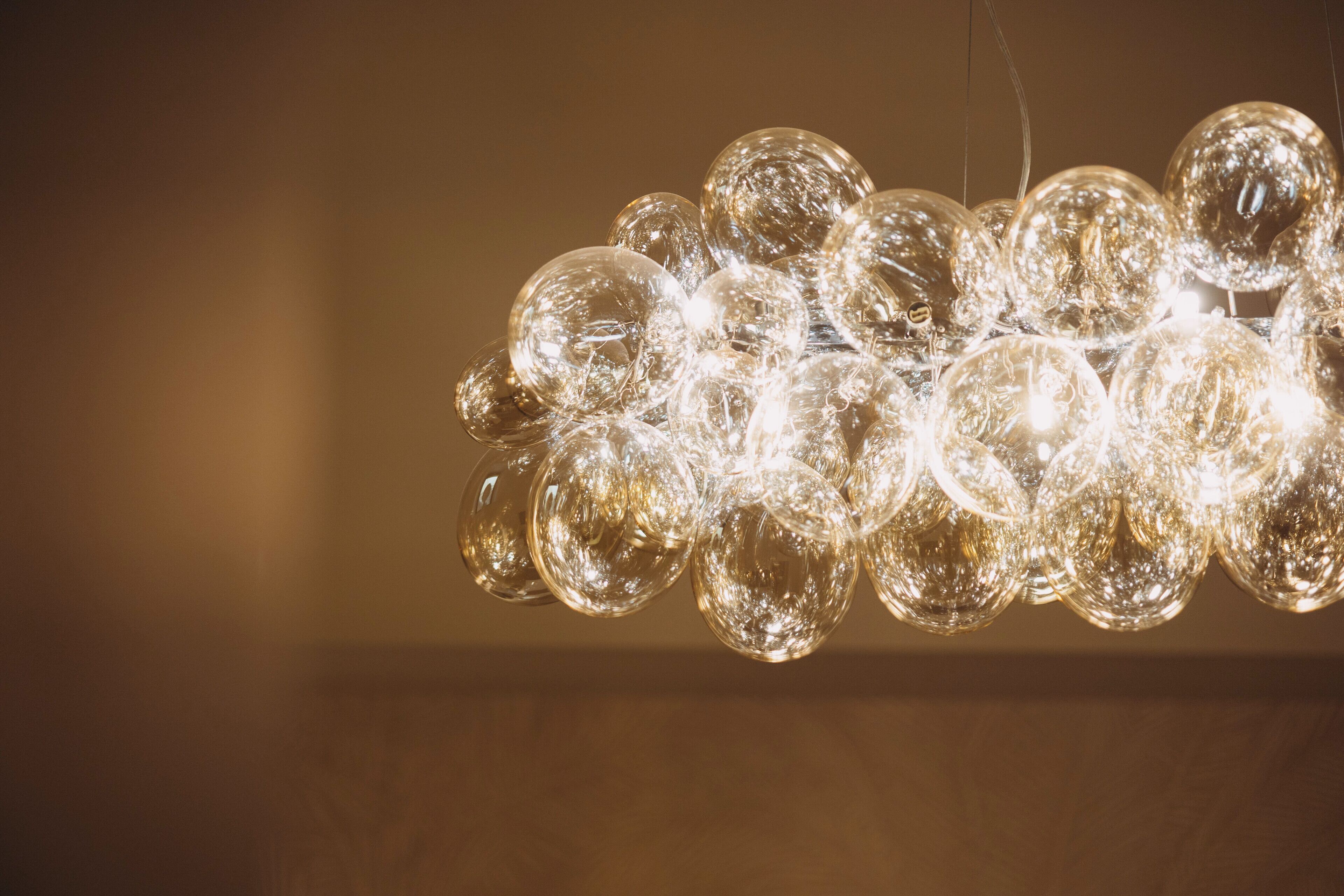 A chandelier with multiple spherical glass bulbs.