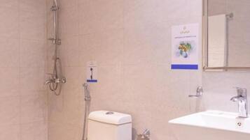 A modern bathroom with a toilet, bidet, and sink.