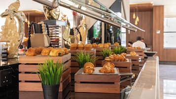 A bakery counter with pastries and a coffee machine.