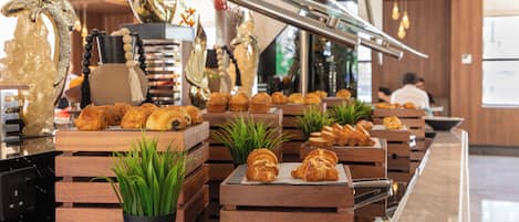 A bakery counter with pastries and a coffee machine.