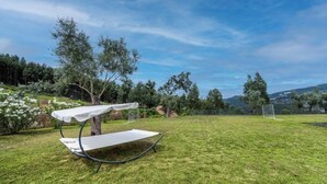 A grassy outdoor area with a hammock-style seating area and a soccer goal in the background. - MyStay - Varanda de Basto (Canedo de Basto)