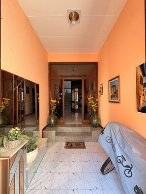 A hotel lobby with a marble floor, a reception desk, a covered seating area, and a staircase leading to the upper floors. - Between the City and the Waterfall, modern and welcoming - Free Parking & Free Entertainment (Terni)