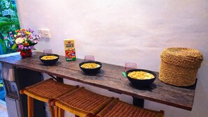 A kitchen counter with bowls of cereal, a carton of juice, and a woven basket. - Luxury 3-BR Villa, Canggu Berawa , Private Pool (Kec. Kuta Utara)