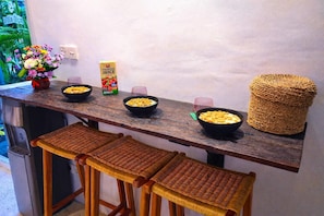 A kitchen counter with bowls of cereal, a carton of juice, and a woven basket. - Luxury 3-BR Villa, Canggu Berawa , Private Pool (Kec. Kuta Utara)