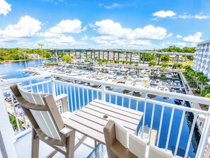 A balcony with a view of a marina and a bridge. - Waterway View Marina Retreat: Harbourgate Marina Club Unit 504 (North Myrtle Beach)