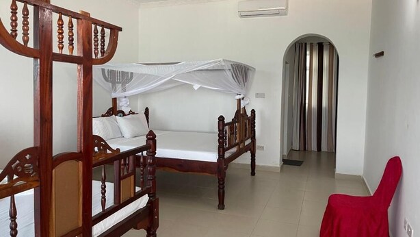 Deluxe Double or Twin Room, Balcony, Garden View | In-room safe, blackout curtains, iron/ironing board (on request) - Visitors Inn  (Jambiani)