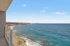A coastal view from a balcony with a clear sky, rocky coastline, and the ocean. - Vacation Apartment 'The Cliff View B' with Sea View, Private Terrace and Wi-Fi (La Estrella)