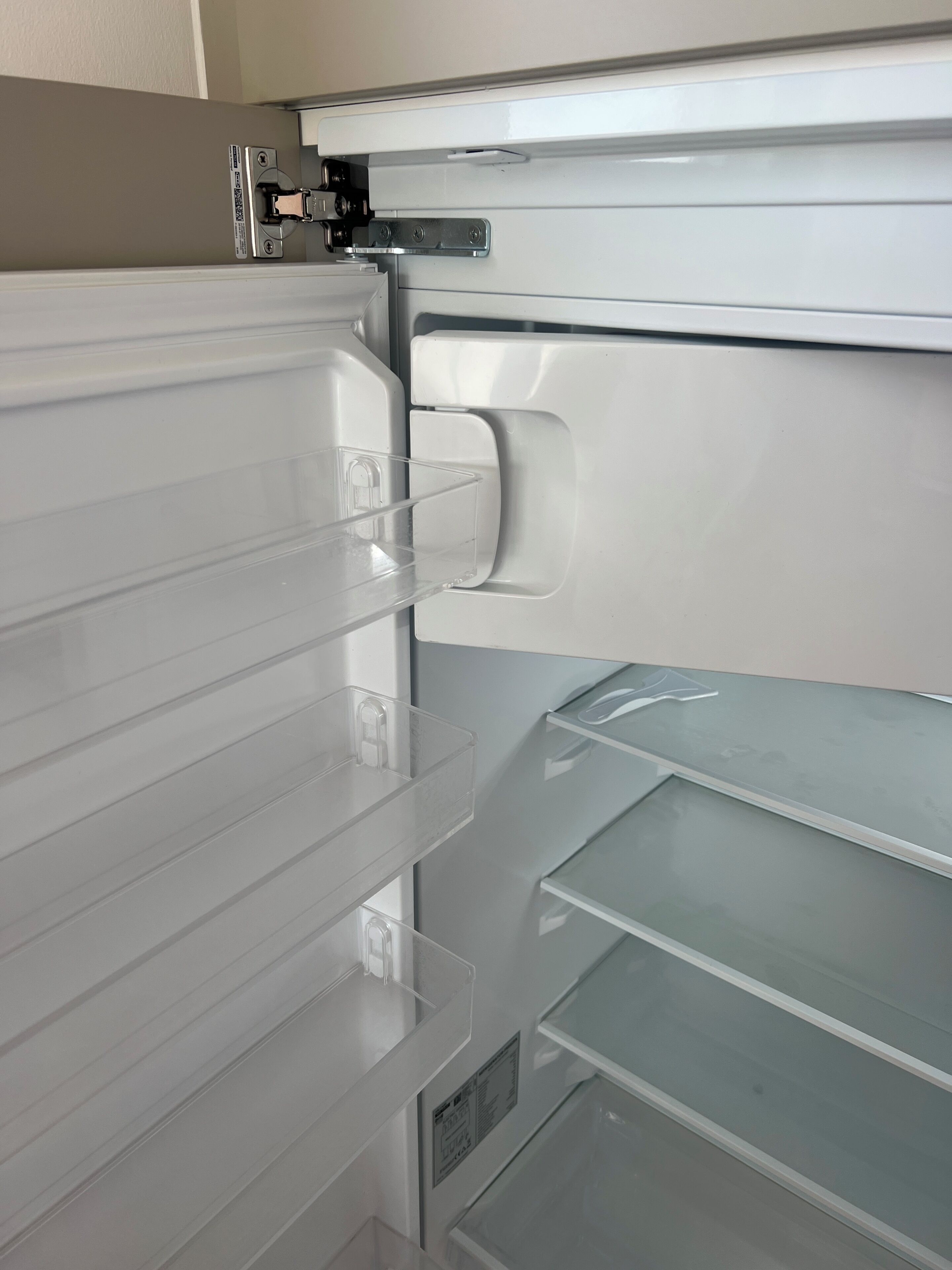 A refrigerator with multiple shelves and a freezer compartment.