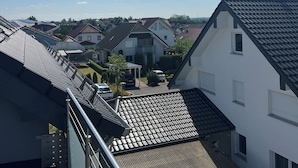A residential area with houses, a clear sky, and a metal staircase.