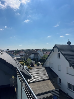 A residential area with houses, a clear sky, and a metal staircase.