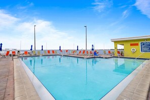 A swimming pool with multiple lanes, surrounded by lounge chairs and a lifeguard station. - Tampa Bay 1BR Retreat w/ Pool & Full Kitchen (Tampa)