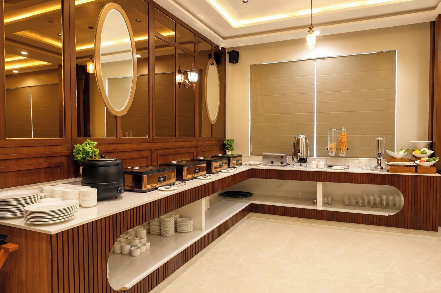 A modern bathroom with a vanity, mirrors, and a coffee station.