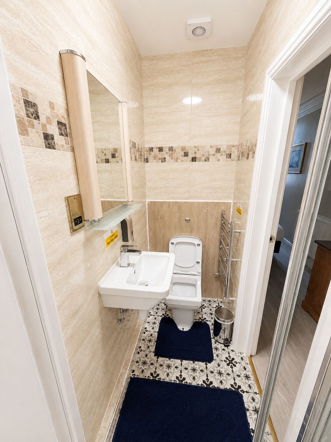 A bathroom with a sink, toilet, and shower area.