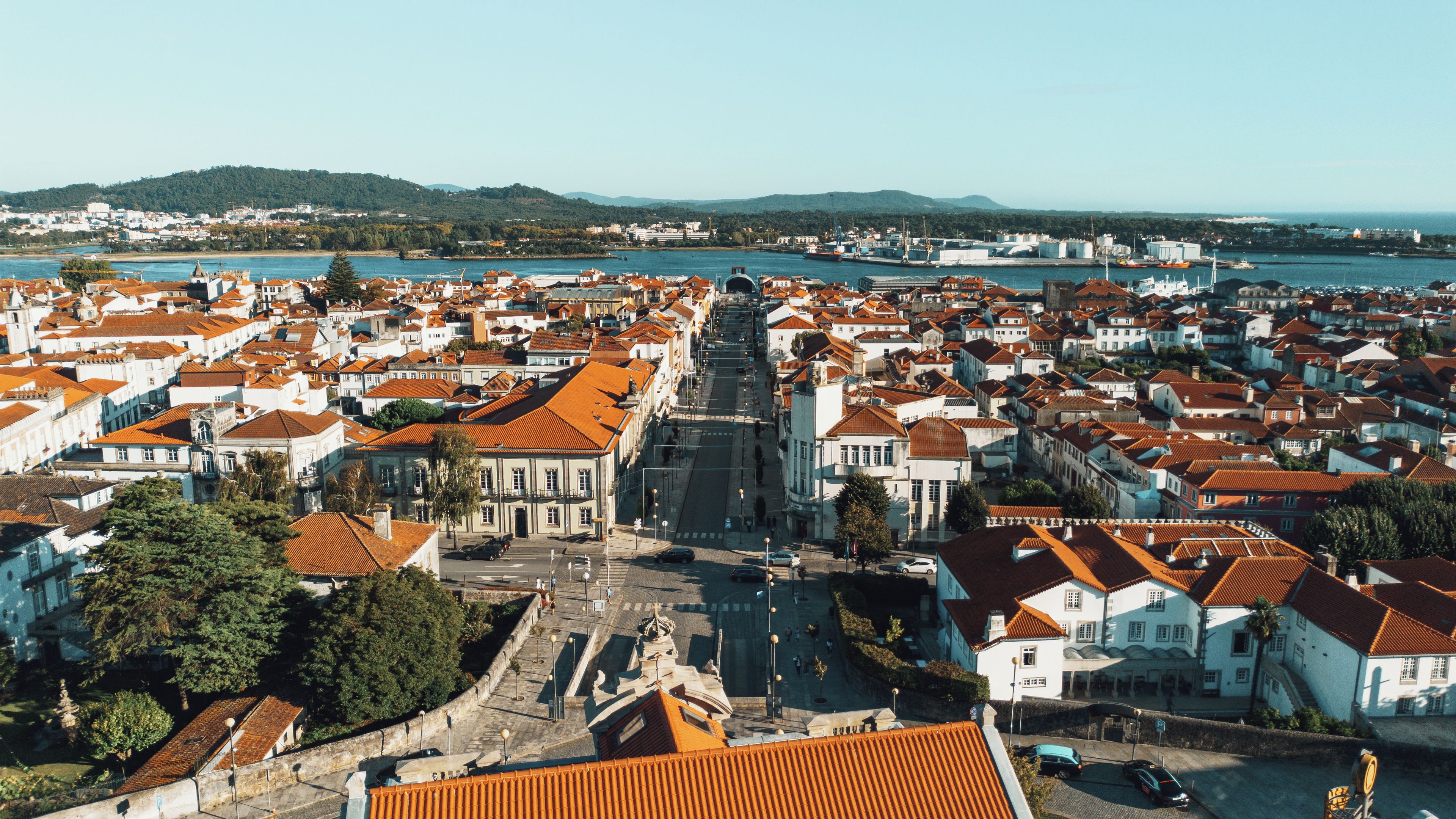 A coastal cityscape with a central square, historic buildings, and a waterfront.