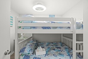 A bunk bed with two levels, each with a patterned bedspread. - Royal Garden Resort 1214 (Murrells Inlet)