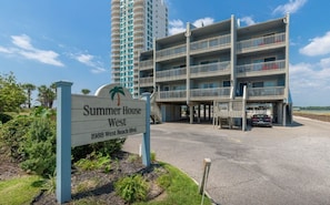 A multi-story hotel named 'Summer House West' with a sign indicating its address.