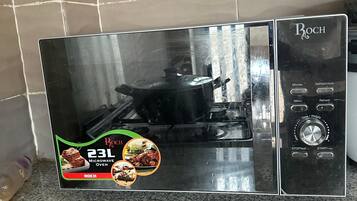 Cozinha com micro-ondas e visor digital.
