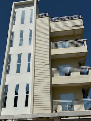 A multi-story building with balconies and windows.
