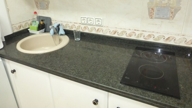 A kitchen with a sink, faucet, countertop, and stove. - 1 Bedroom Apartment at 50 Meters From the Beach (Roquetas de Mar)