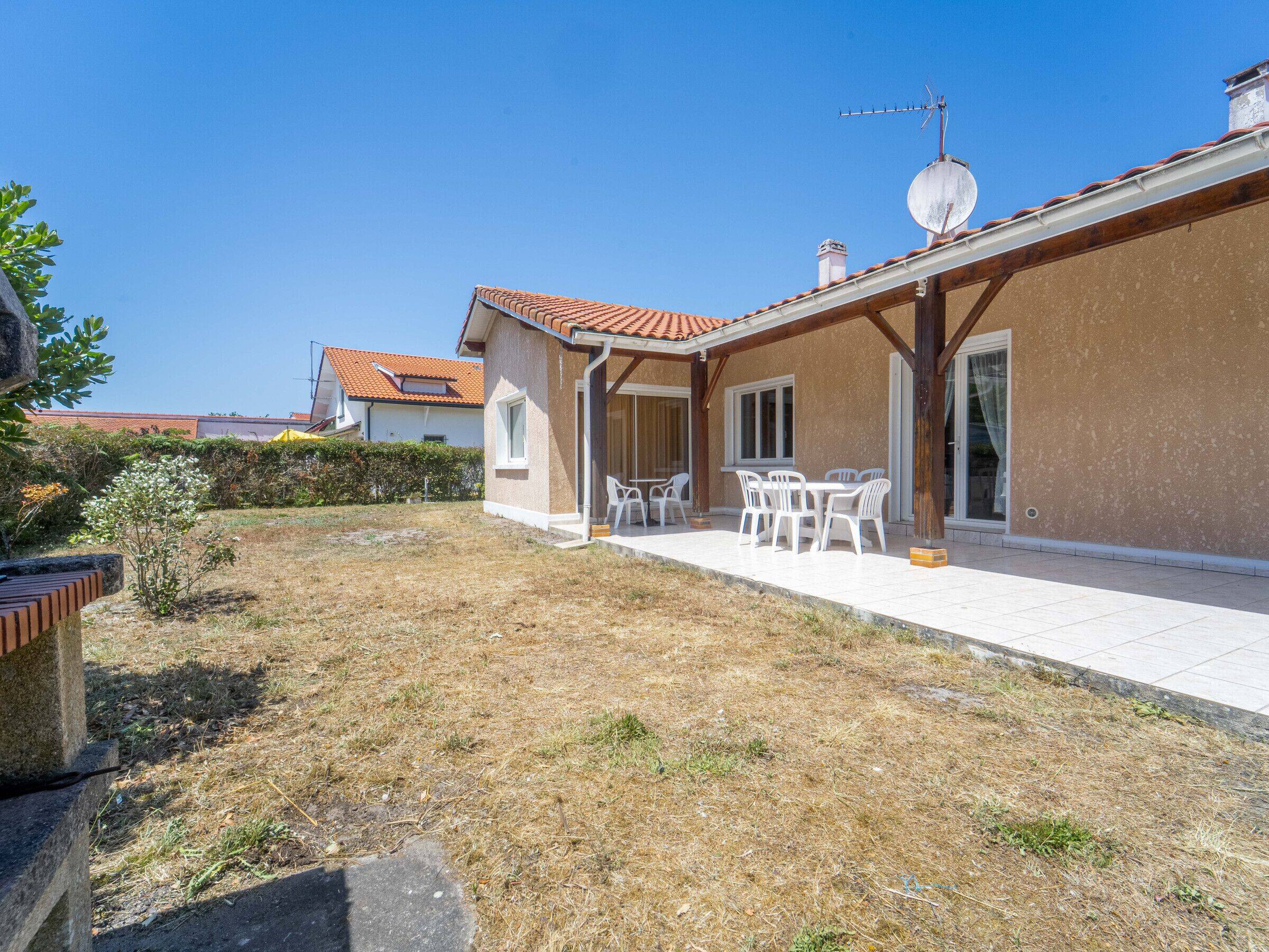 A residential property with a patio area, outdoor seating, and a satellite dish.