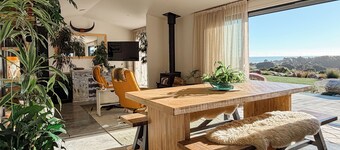 Brand new and beautifully designed, this striking ridge-top retreat blends modern industrial style with lush botanicals and breathtaking West Coast views. It’s the perfect place to slow down, gather around the fire and watch unforgettable sunsets.