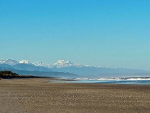 A beach with a mountain range in the background.